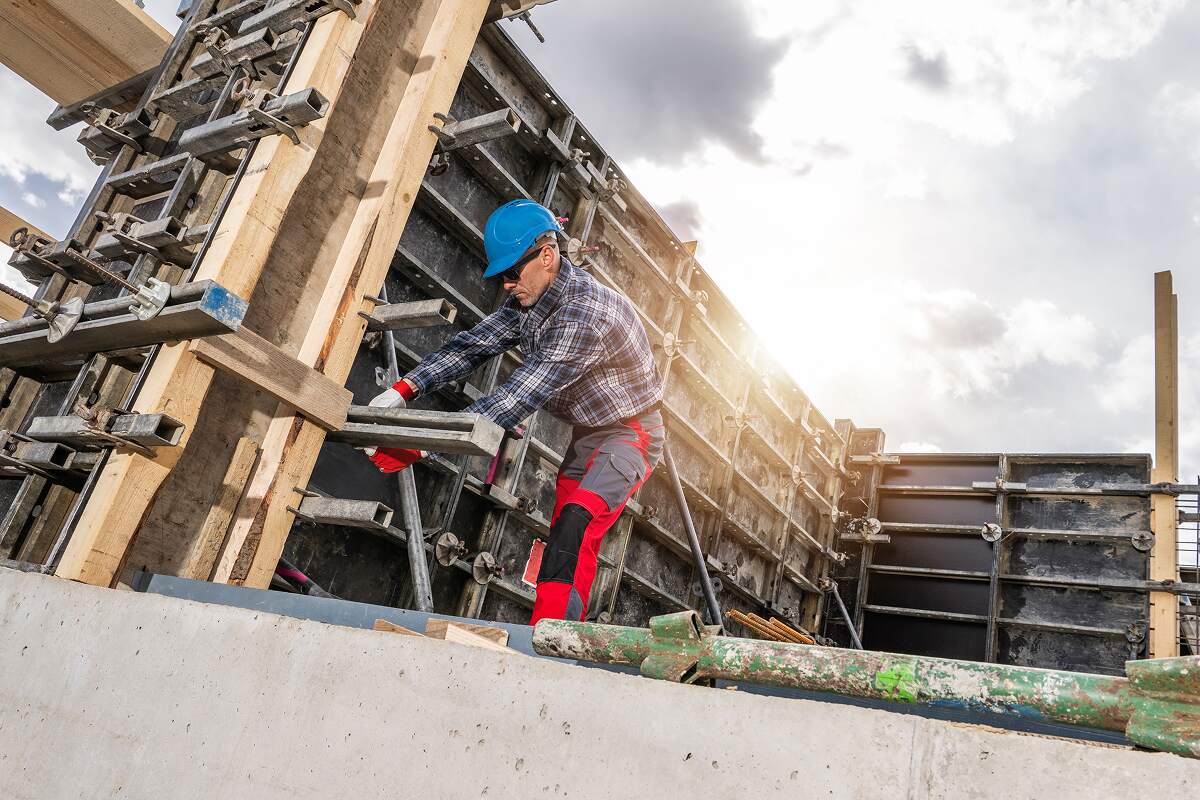 construction worker fabricates concrete formwork o UYHLC5L
