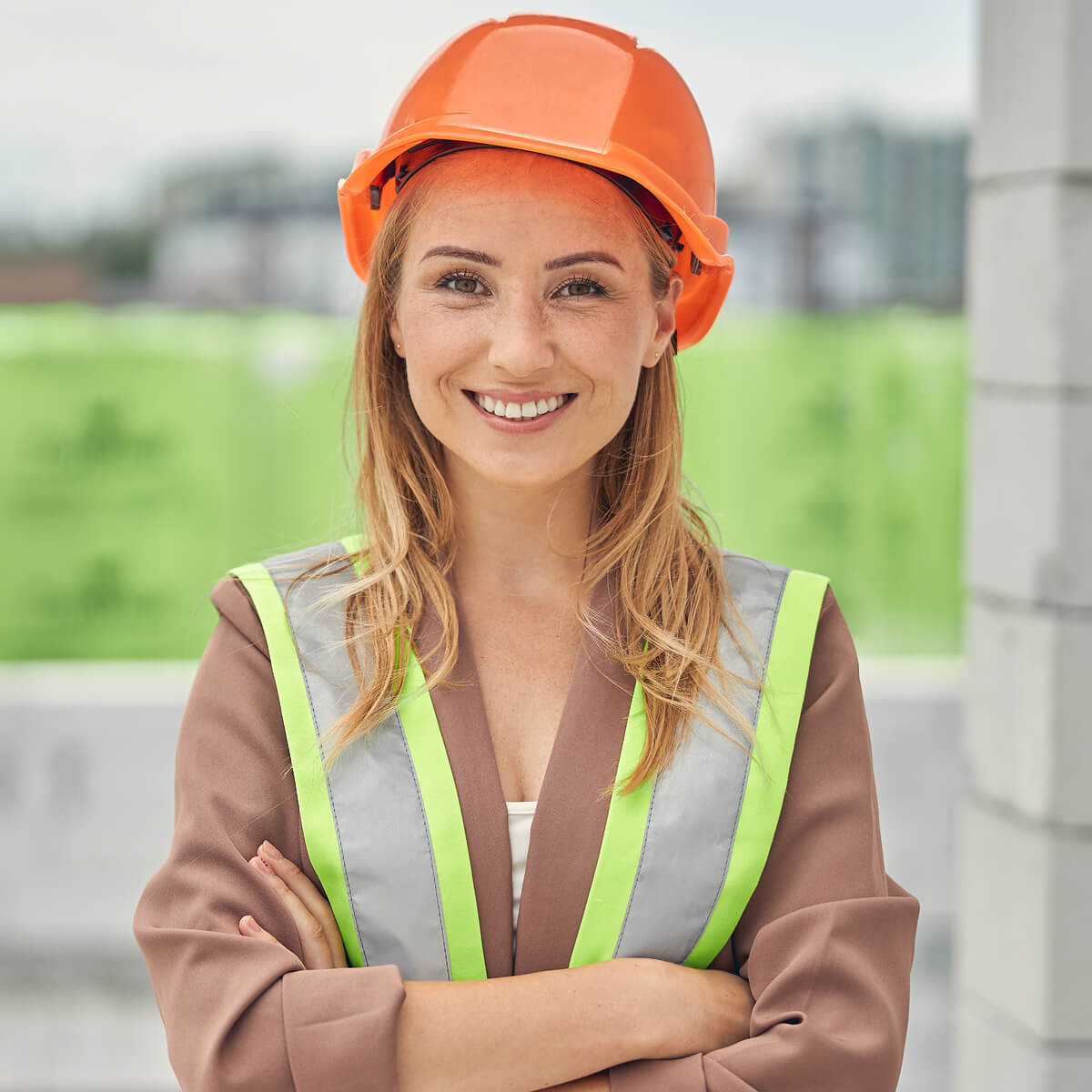 smiling beautiful joyous woman engineer looking fo KFA9J4W
